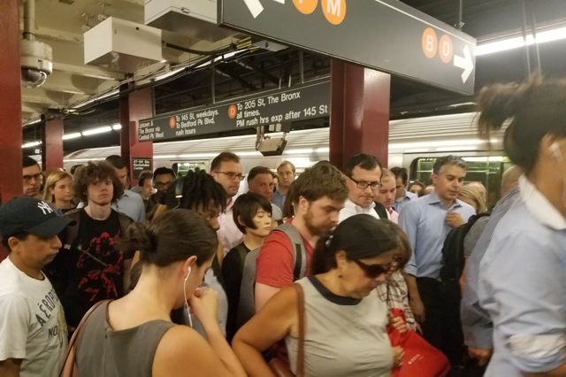 Great job, everyone: Subway passengers leave Rockefeller Center after a classic commute